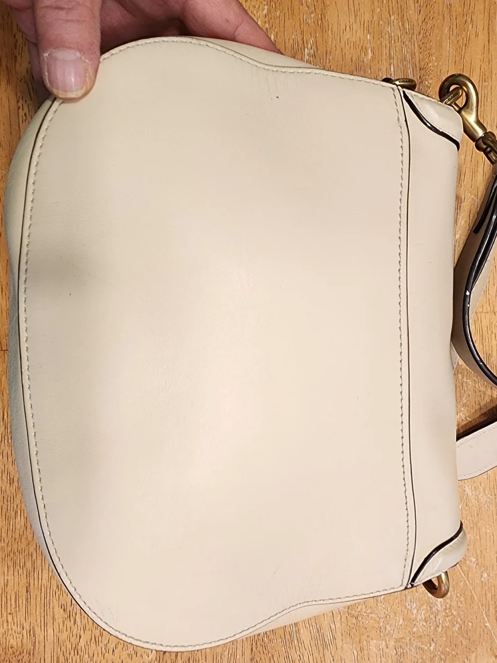 2021 Ivory Coach Beat saddle bag is crafted from glovetanned leather and brass